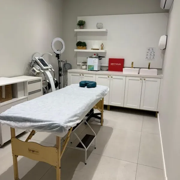 Sala de procedimentos corporais da Harmonelle, com maca e equipamento